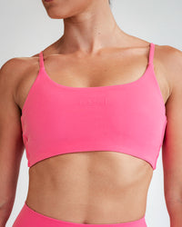 Woman wearing Twist Sports Bra - Carmine Rose