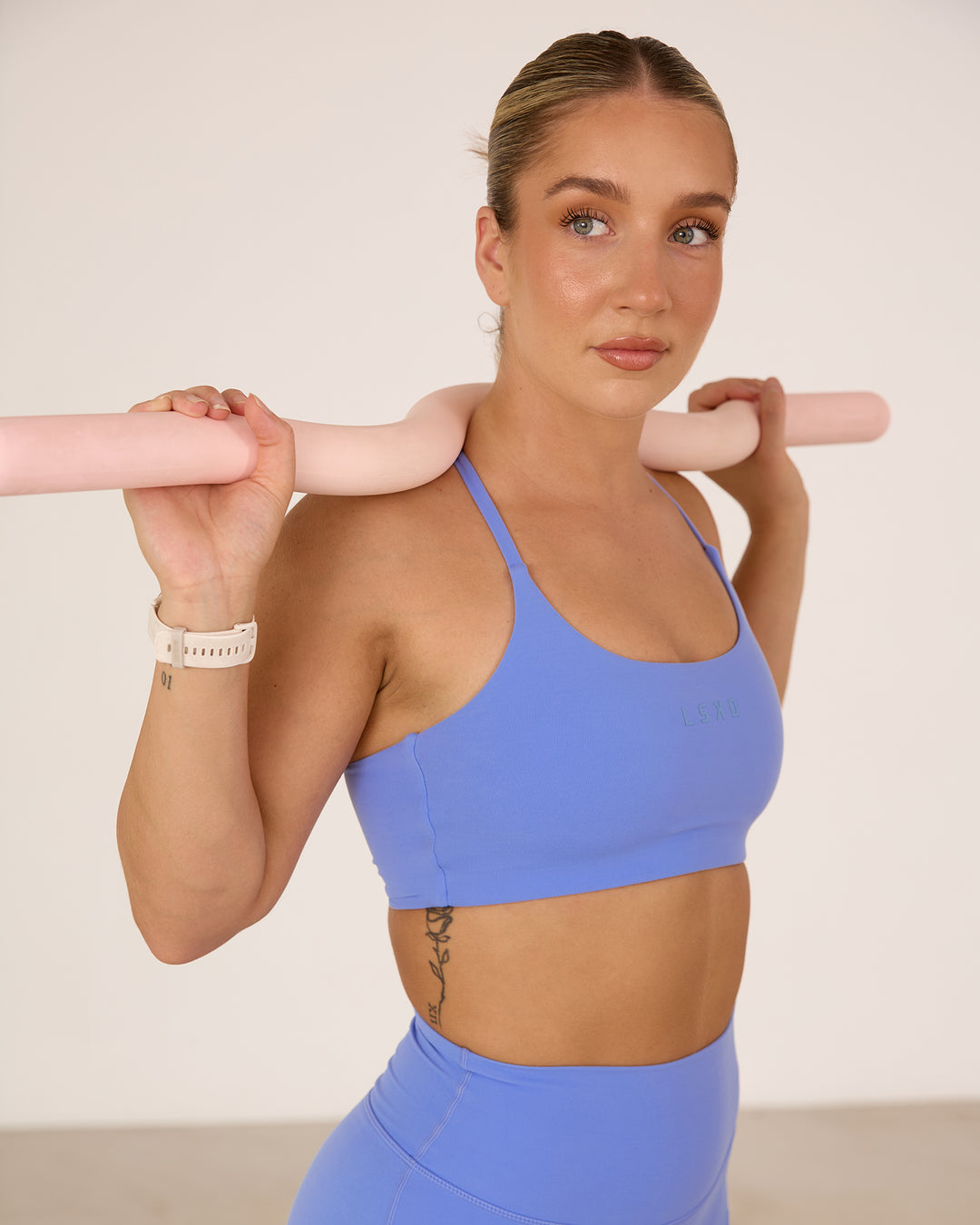 Woman wearing Twist Sports Bra - Indulgent Blue