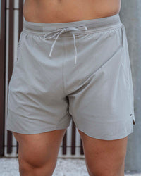 Man wearing UltraAir 5" Lined Performance Shorts - Circular Grey
