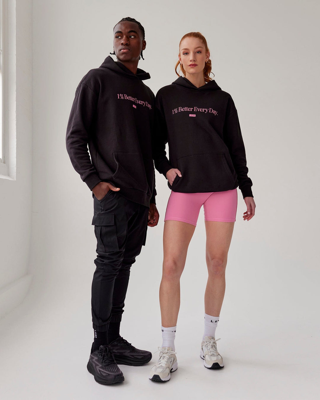 Duo wearing Unisex 1% Better Hoodie Oversize - Black-Pink Rose