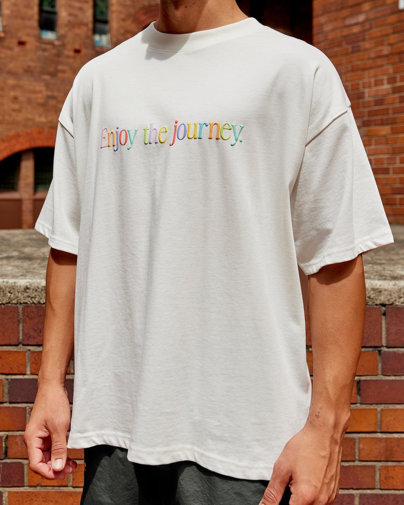 Man wearing Unisex Enjoy The Journey Heavyweight Tee Oversize - Off White-Multi