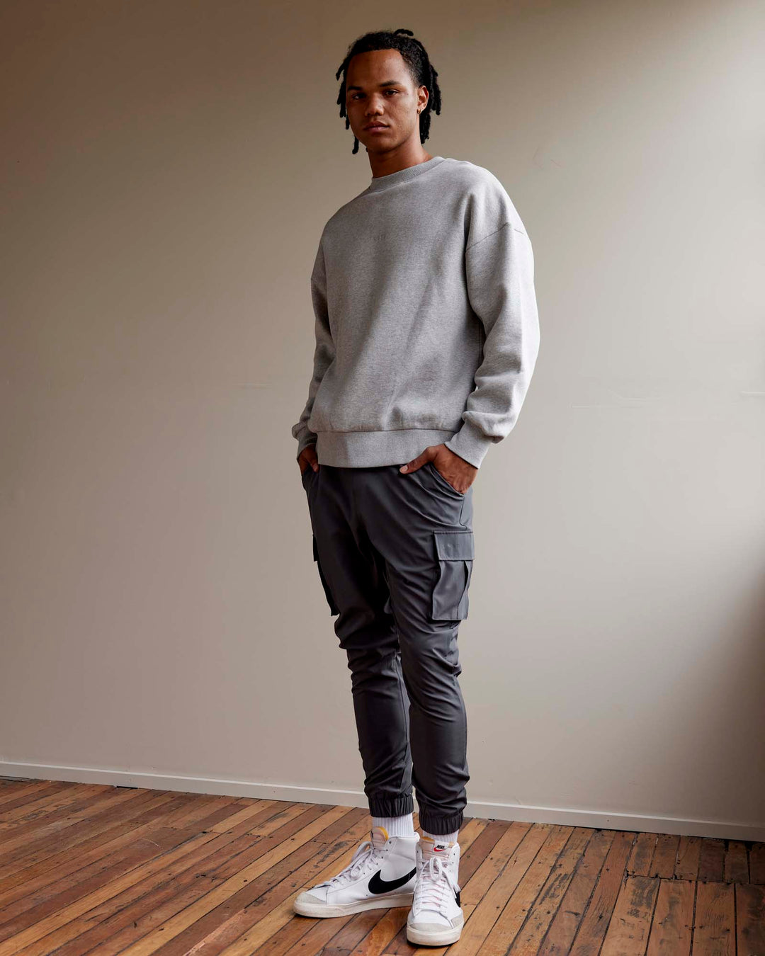 Man wearing Unisex MVP Sweater Oversize - Lt Grey Marl
