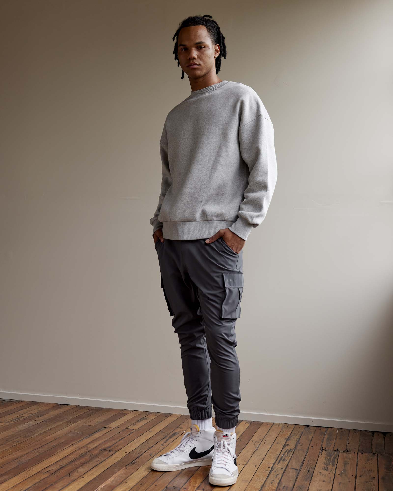 Man wearing Unisex MVP Sweater Oversize - Lt Grey Marl