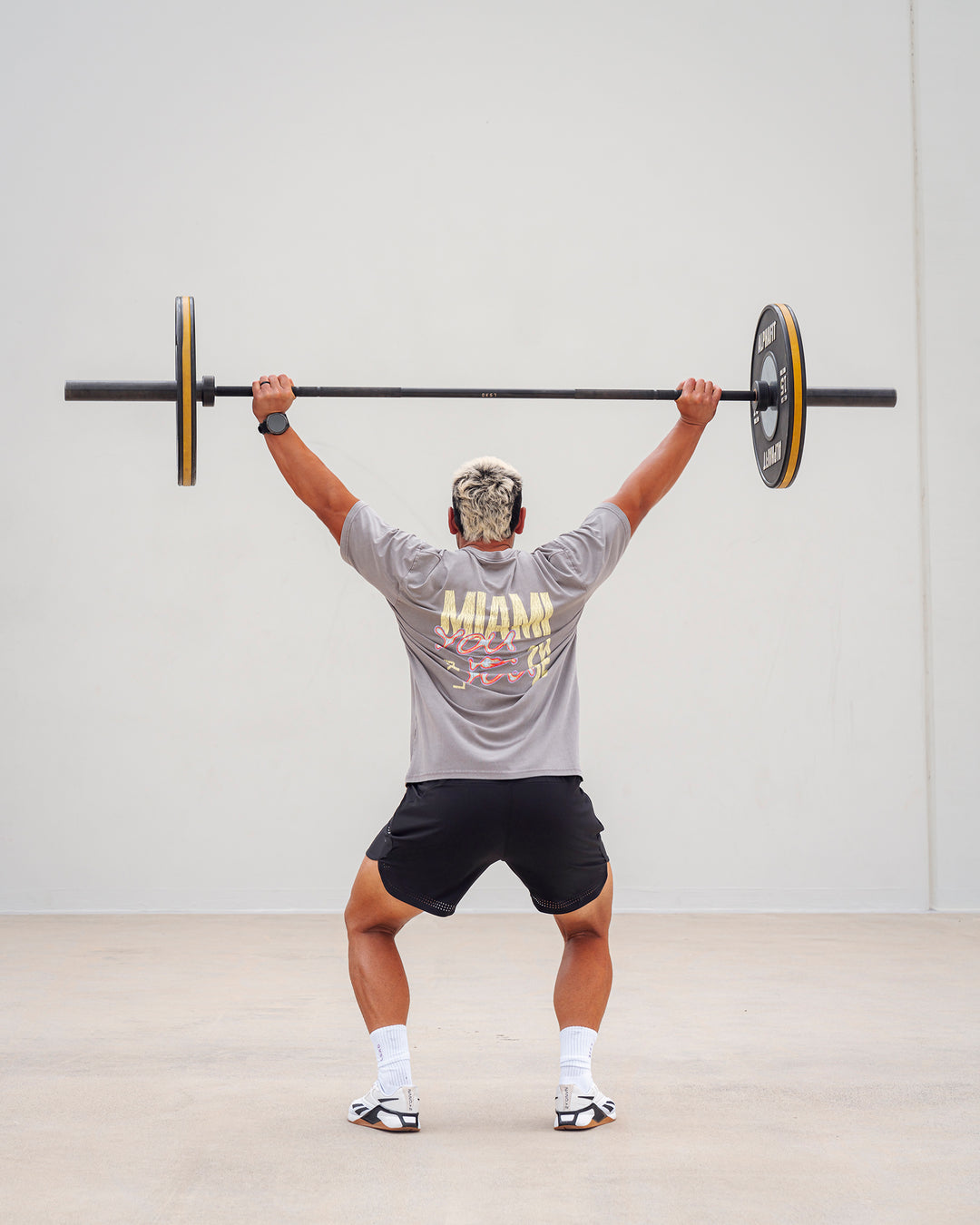 Man wearing Unisex Miami25 Washed FLXCotton Tee Oversize - Storm Front-Lemon Fizz