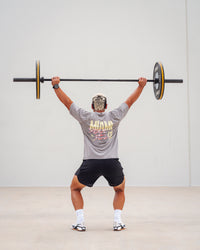 Man wearing Unisex Miami25 Washed FLXCotton Tee Oversize - Storm Front-Lemon Fizz