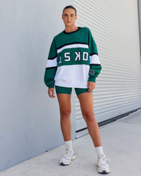 Woman wearing Unisex PrimeTime Sweater Oversize - Malachite-White