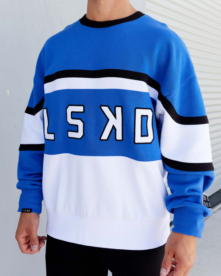 Man wearing Unisex PrimeTime Sweater Oversize - Power Cobalt-White