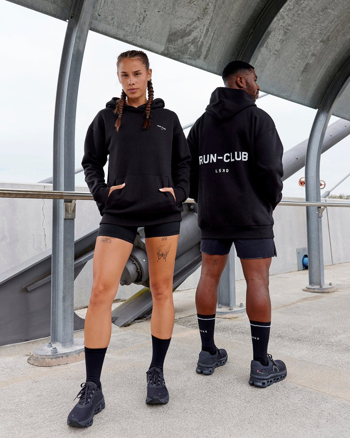 Duo wearing Unisex RUN-CLUB Hoodie Oversize - Black