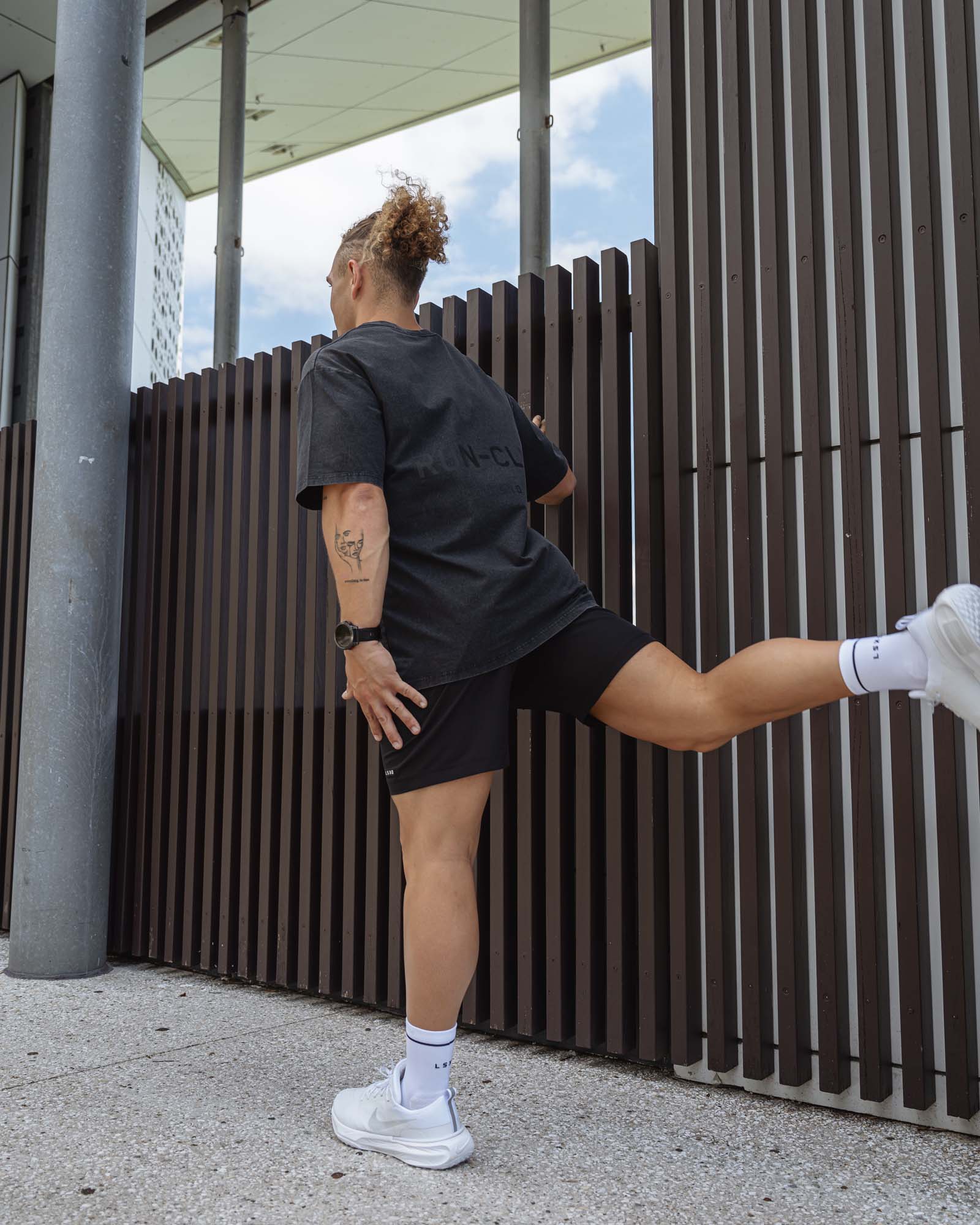 Man wearing Unisex Washed RUN CLUB FLXCotton Tee Oversize - Black-Black