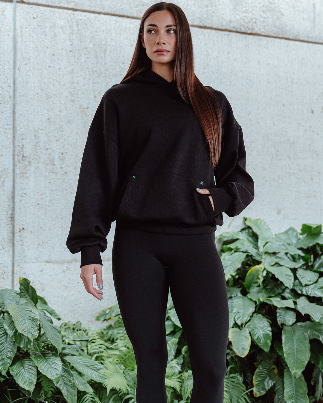 Woman wearing Unisex We Rise Hoodie Oversize - Black-Impact Green