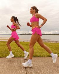 Woman wearing Velocity Sports Bra - Ultra Pink | Model:Duo | Size:Both