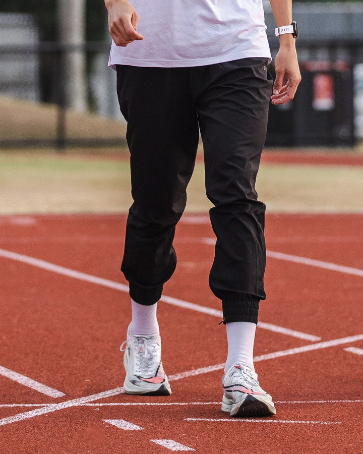 Man wearing Warm Up Zip Cuff Performance Pant - Black