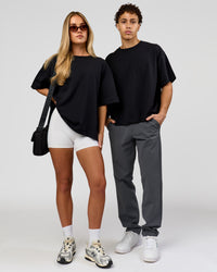 Duo wearing AfterDark ZeroCrease Boxy Tee in Black | Model:Issy | Size:XS | Model:Leandro | Size:M