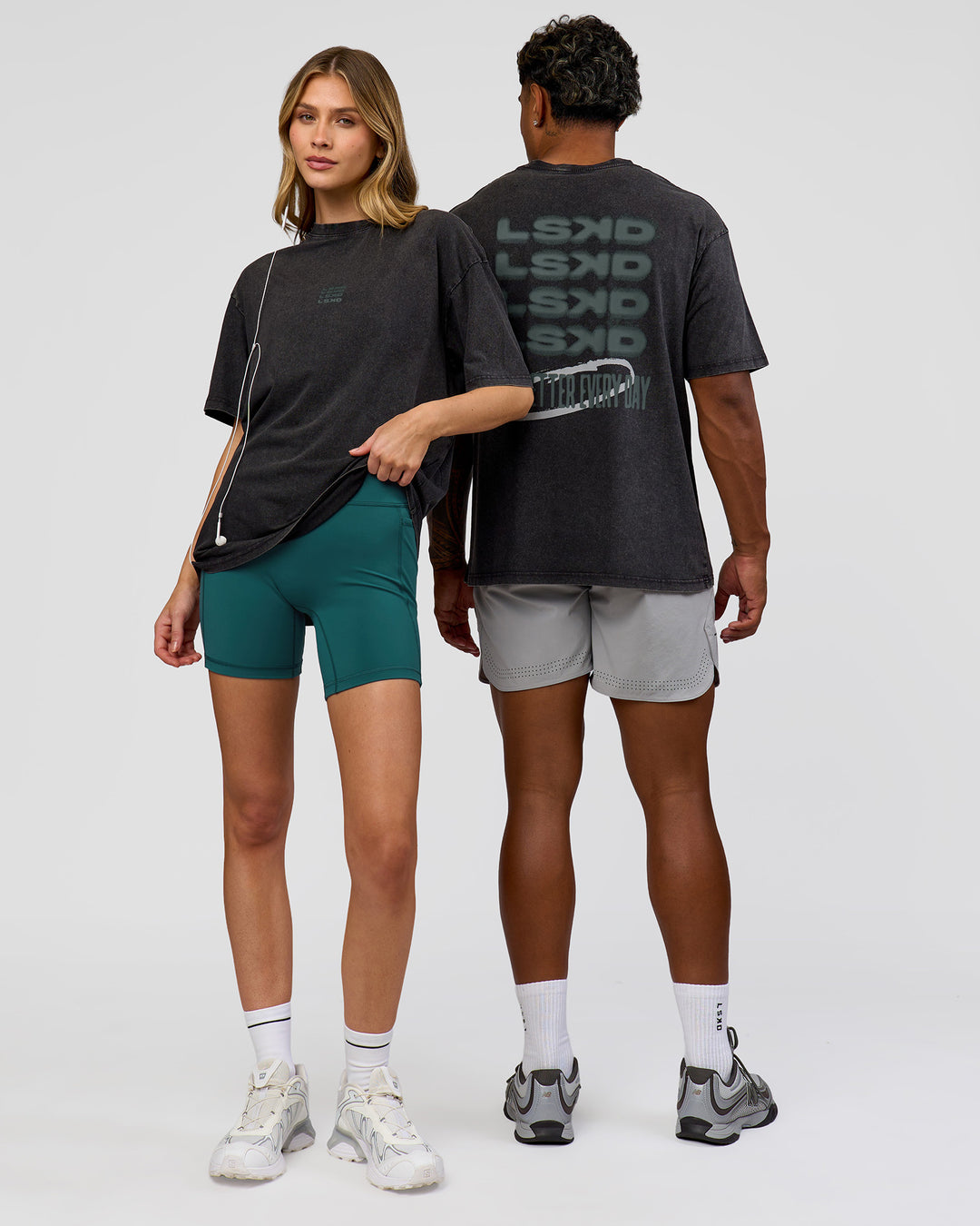 Duo wearing Everyday Elevation FLXCotton Oversized Tee - Black Washed-Carbon Green | Model:Leilani | Size:XS | Model:Xav | Size:L
