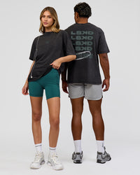 Duo wearing Everyday Elevation FLXCotton Oversized Tee - Black Washed-Carbon Green | Model:Leilani | Size:XS | Model:Xav | Size:L