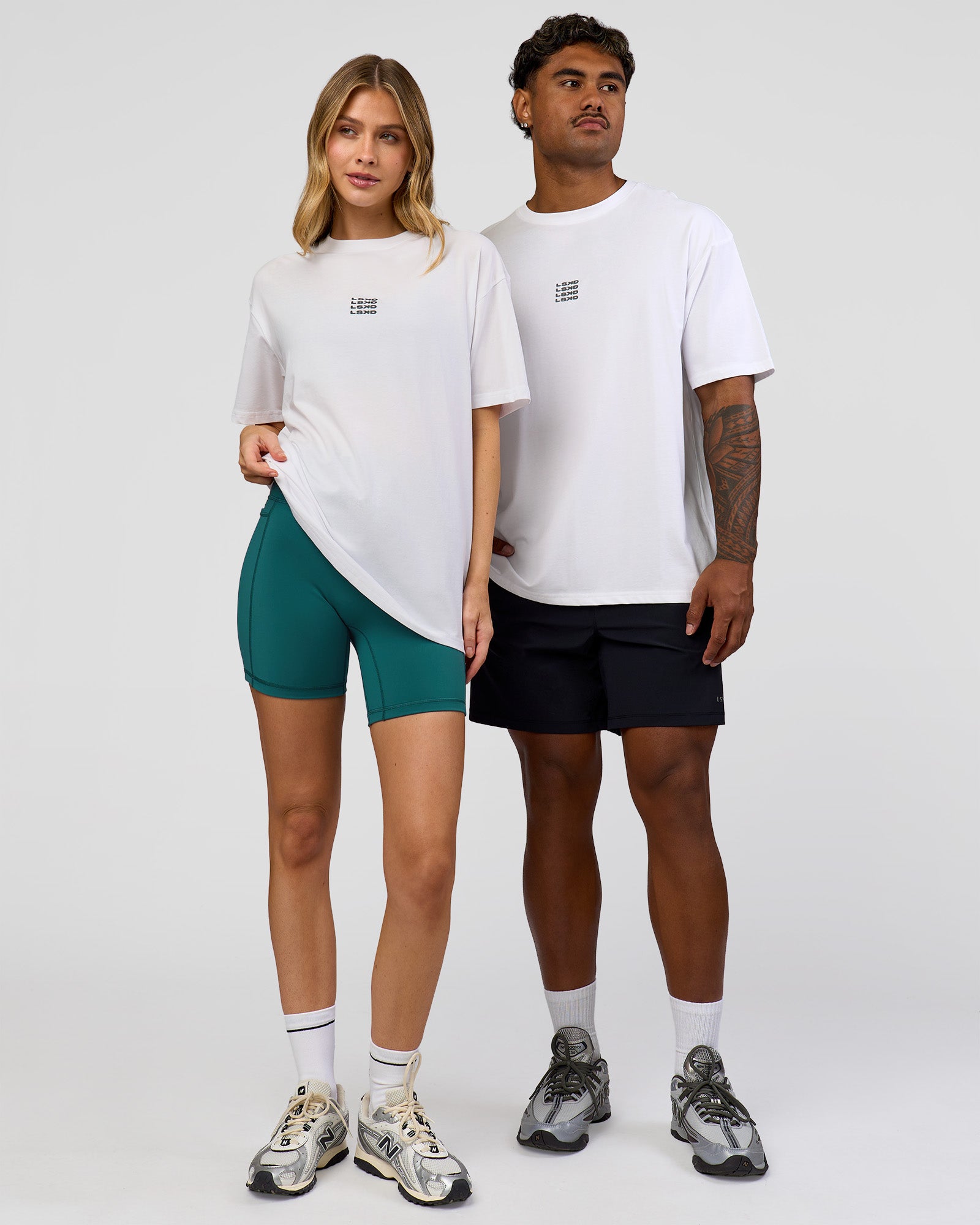 Duo wearing Everyday Elevation FLXCotton Oversized Tee - White-Carbon Green | Model:Leilani | Size:XS | Model:Xav | Size:L