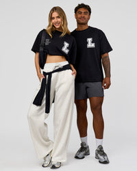 Duo wearing Hype Heavyweight Unisex Oversized Tee - Black-White | Model:Leilani | Size:XS | Model:Xavier | Size:L | Thumbnail Index: 1