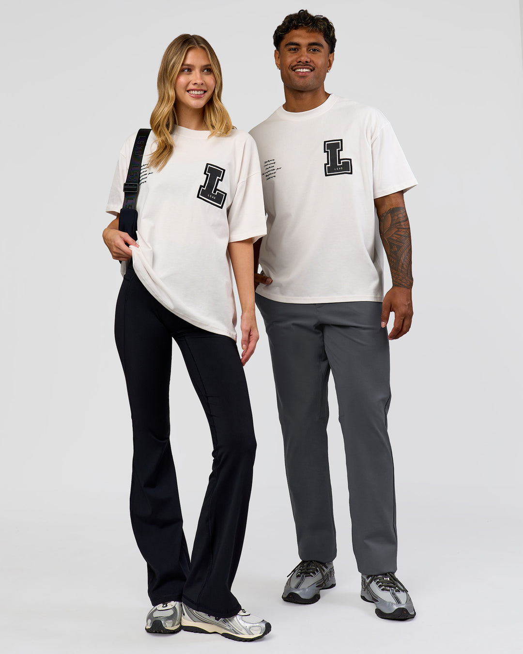 Duo wearing Hype Heavyweight Unisex Oversized Tee - Off White-Black | Model:Xavier | Size:L | Model:Brylee | Size:XS