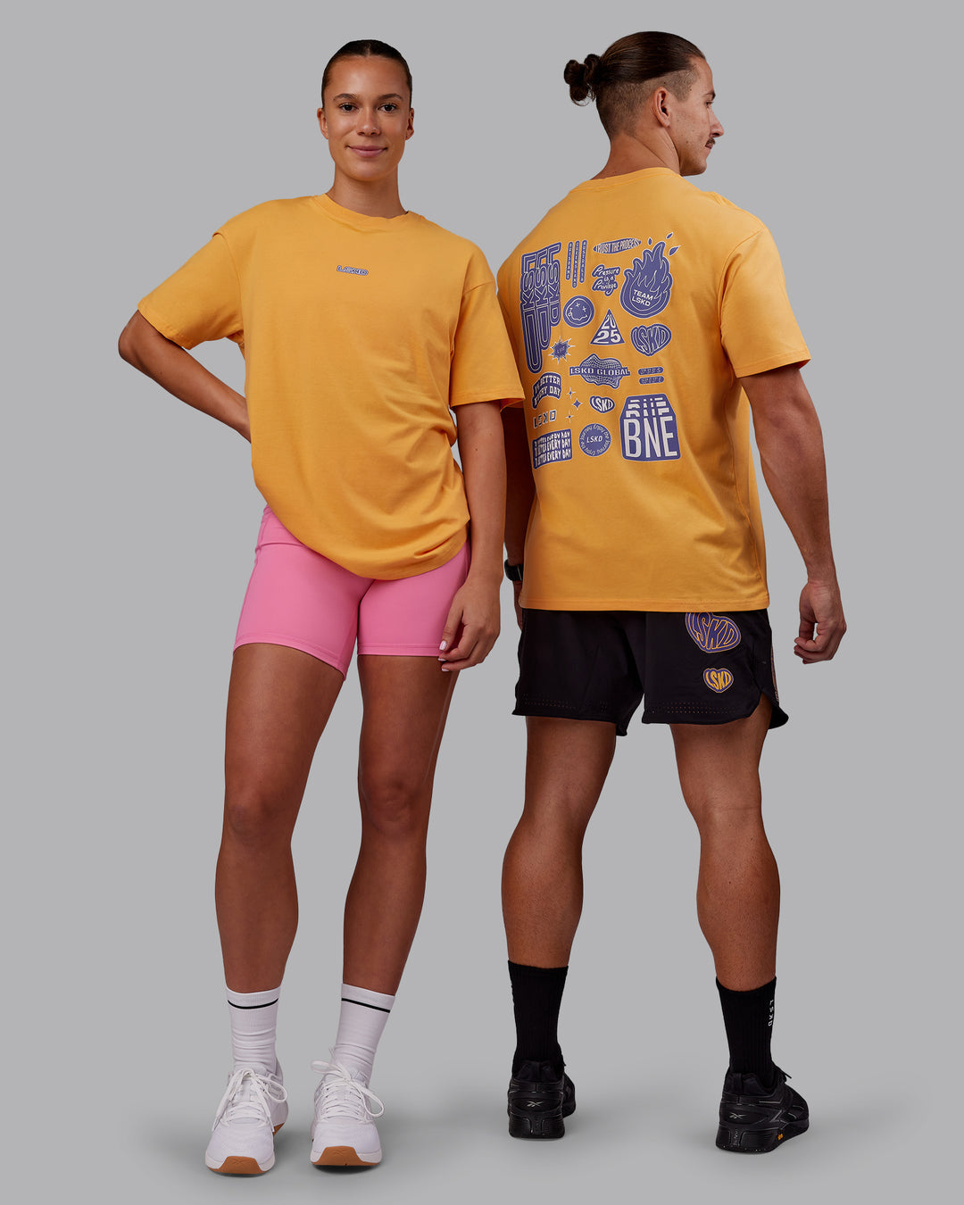 Duo wearing CFT BNE 25 FLXCotton Oversized Tee - Warm Apricot-Purple Opulence | Model:Both | Size:Duo