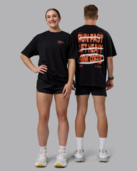 Duo wearing Coffee Run FLXCotton Oversized Tee - Black-Ultra Orange | Model:Duo | Size:Duo