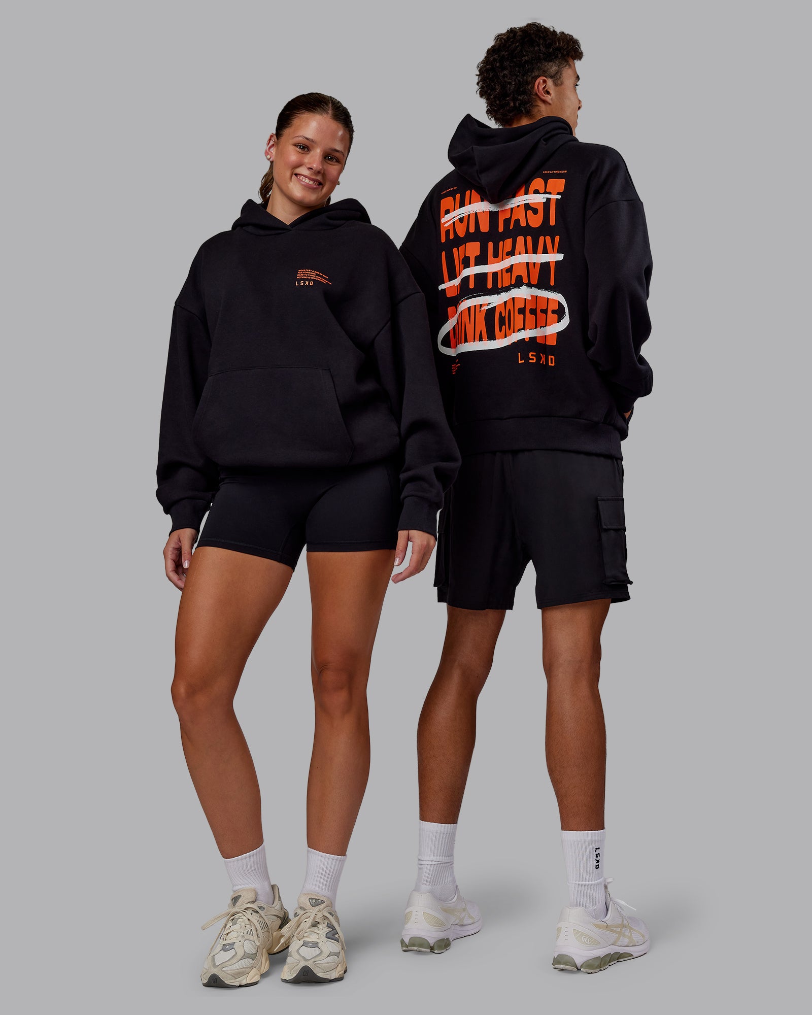 Duo wearing Coffee Run Unisex Oversized Hoodie - Black-Ultra Orange | Model:Duo | SIze:Duo
