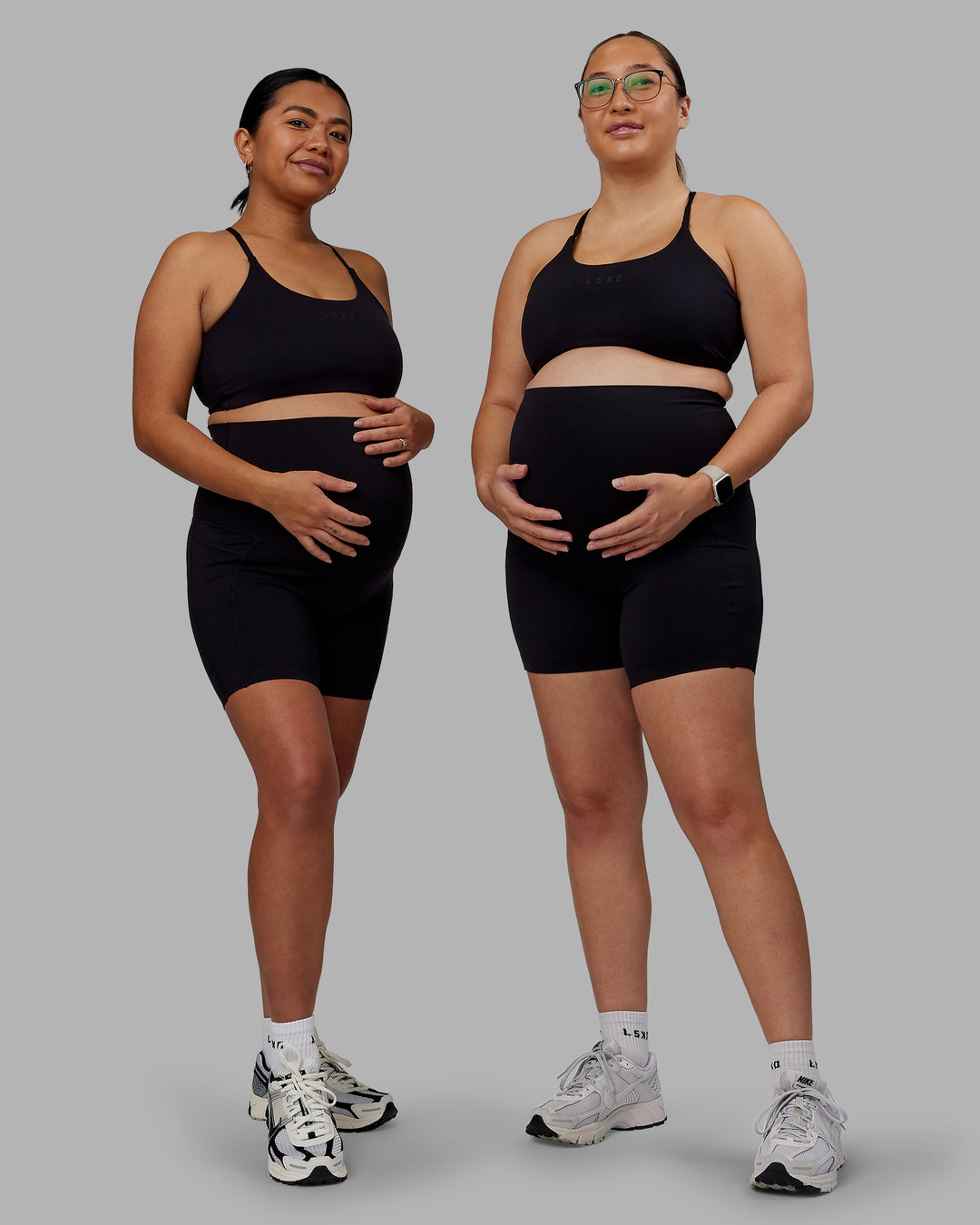 Woman wearing Elixir Ultra High-Rise Maternity 6&quot; Short Pockets - Black | Model:Both | Size:Duo