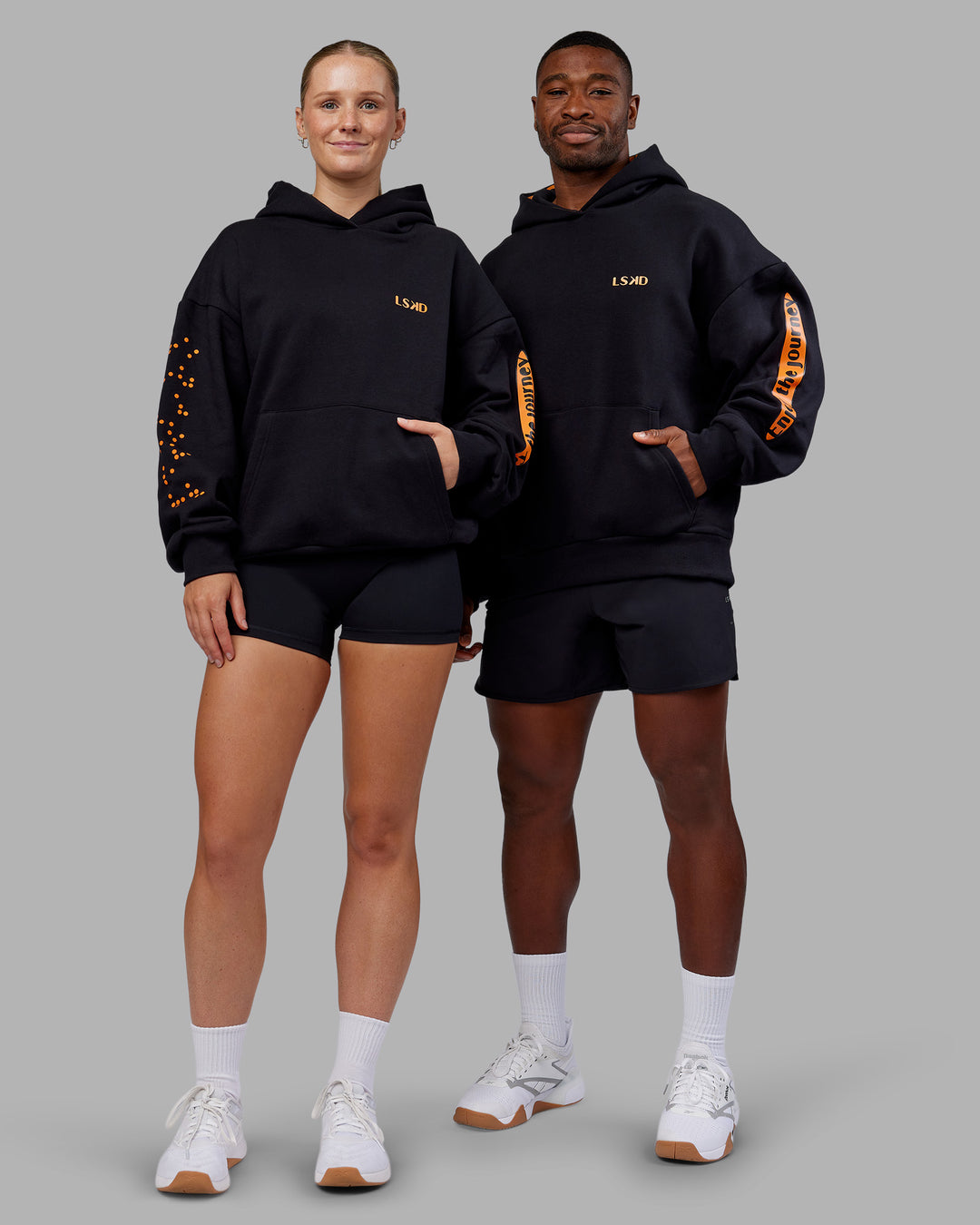 Duo wearing Hyped Unisex Oversized Hoodie - Black-Vibrant Orange | Model:Both | Size:Duo