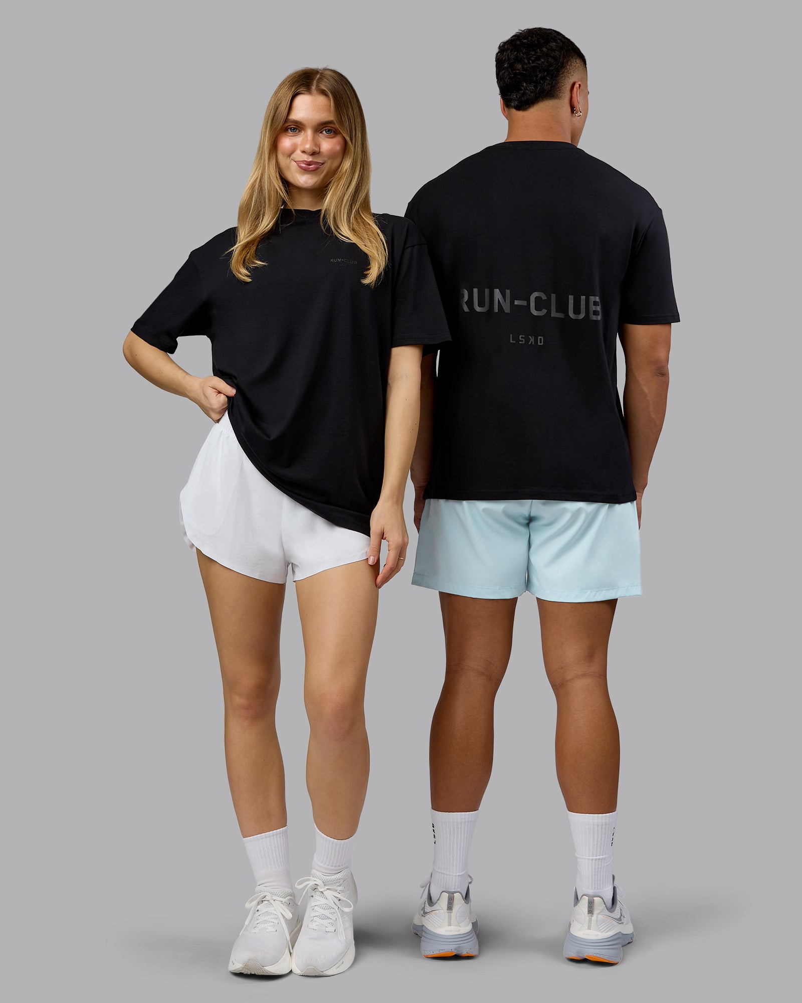 Duo wearing RUN CLUB FLXCotton Tee Oversize - Black-Reflective | Model:Both | Size:Duo