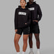 Duo wearing Unisex Strength FLXFLeece Hoodie - Black-White
