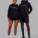 Duo wearing Unisex 1% Better Hoodie Oversize - Black