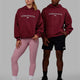 Duo wearing Unisex 1% Better Hoodie Oversize - Cranberry-White
