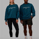 Duo wearing Unisex 1% Better Sweater Oversize - Deep Lagoon-White