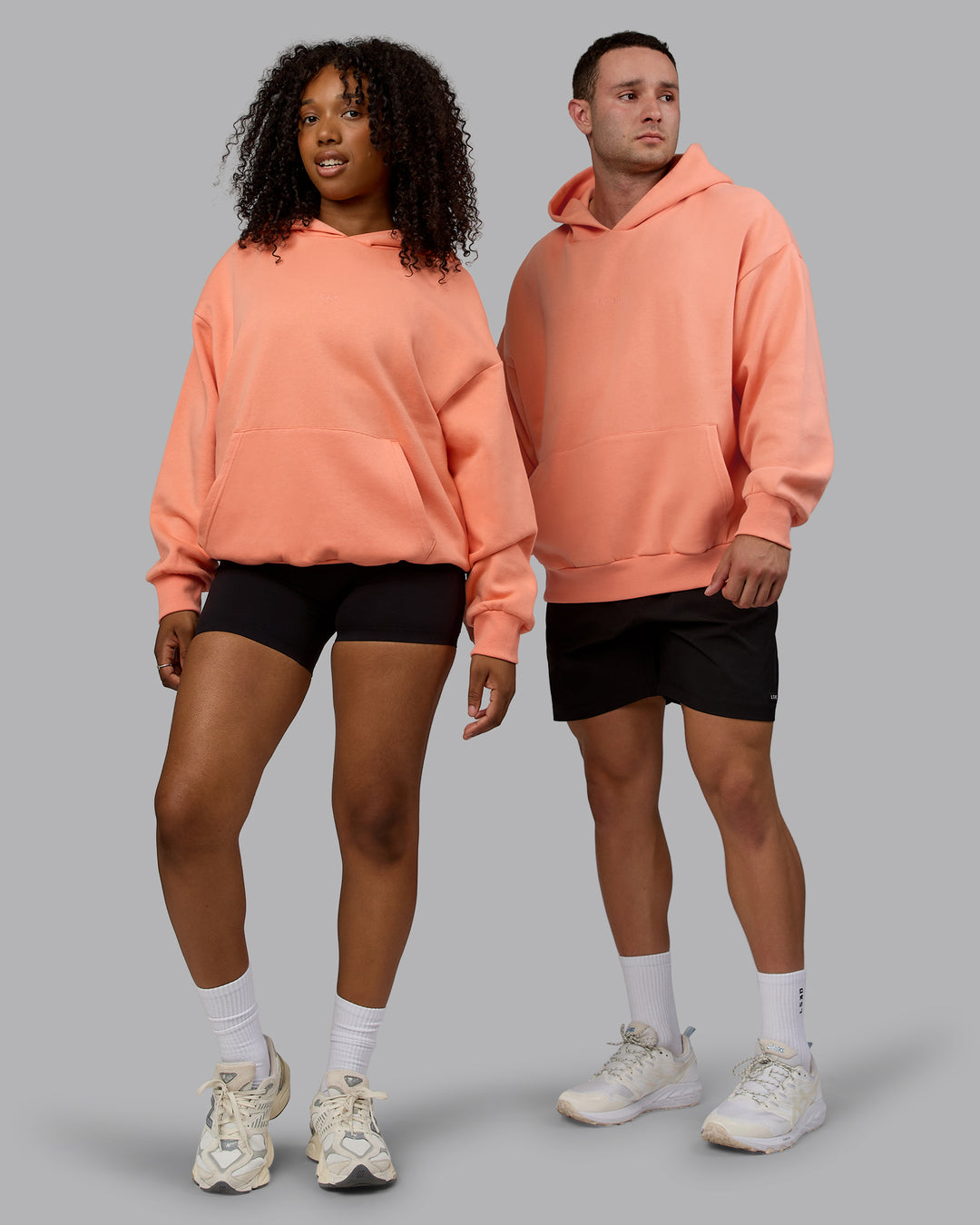 Duo wearing Unisex MVP Hoodie Oversize - Mellow Peach