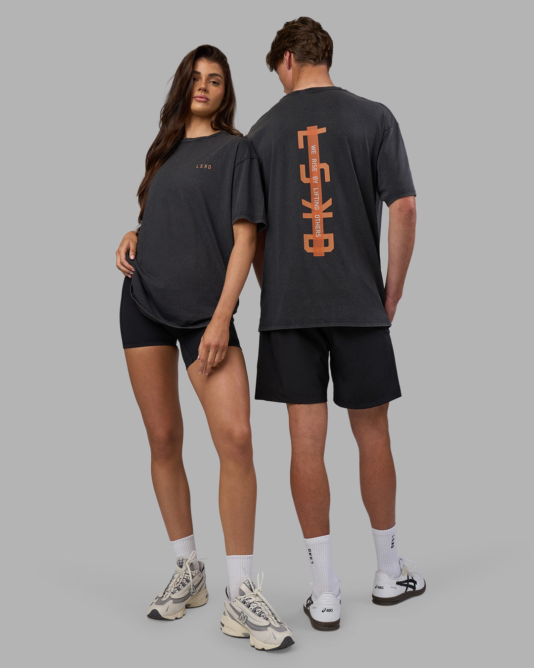 Duo wearing Unisex Strike Through FLXCotton Tee Oversize - Black Washed-Cantaloupe | Model:Both | Size:Duo