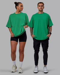 Duo wearing Unisex We Rise Heavyweight Tee Oversize - Impact Green-White