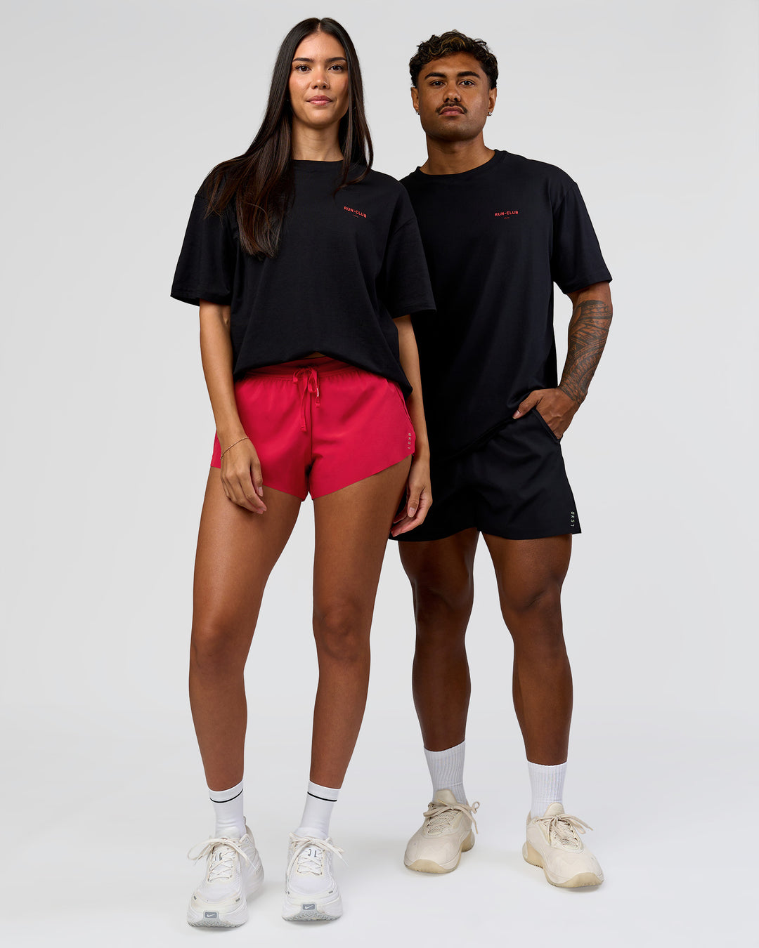 Duo wearing RUN CLUB FLXCotton Tee Oversize - Black-Scarlet | Model:Xav | Size:L | Model:Rhiley | Size:XS