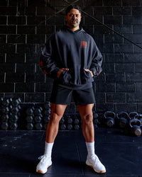 Man wearing Journey Washed Unisex Oversize Hoodie - Black-Ultra Orange | Model:Hiko | Size:L