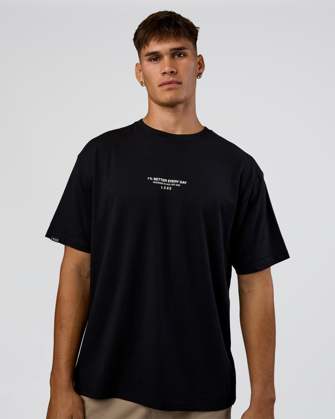 Man wearing 1% Better Every Day EST FLXCotton Oversized Tee - Black | Model:Jackson | Size:L