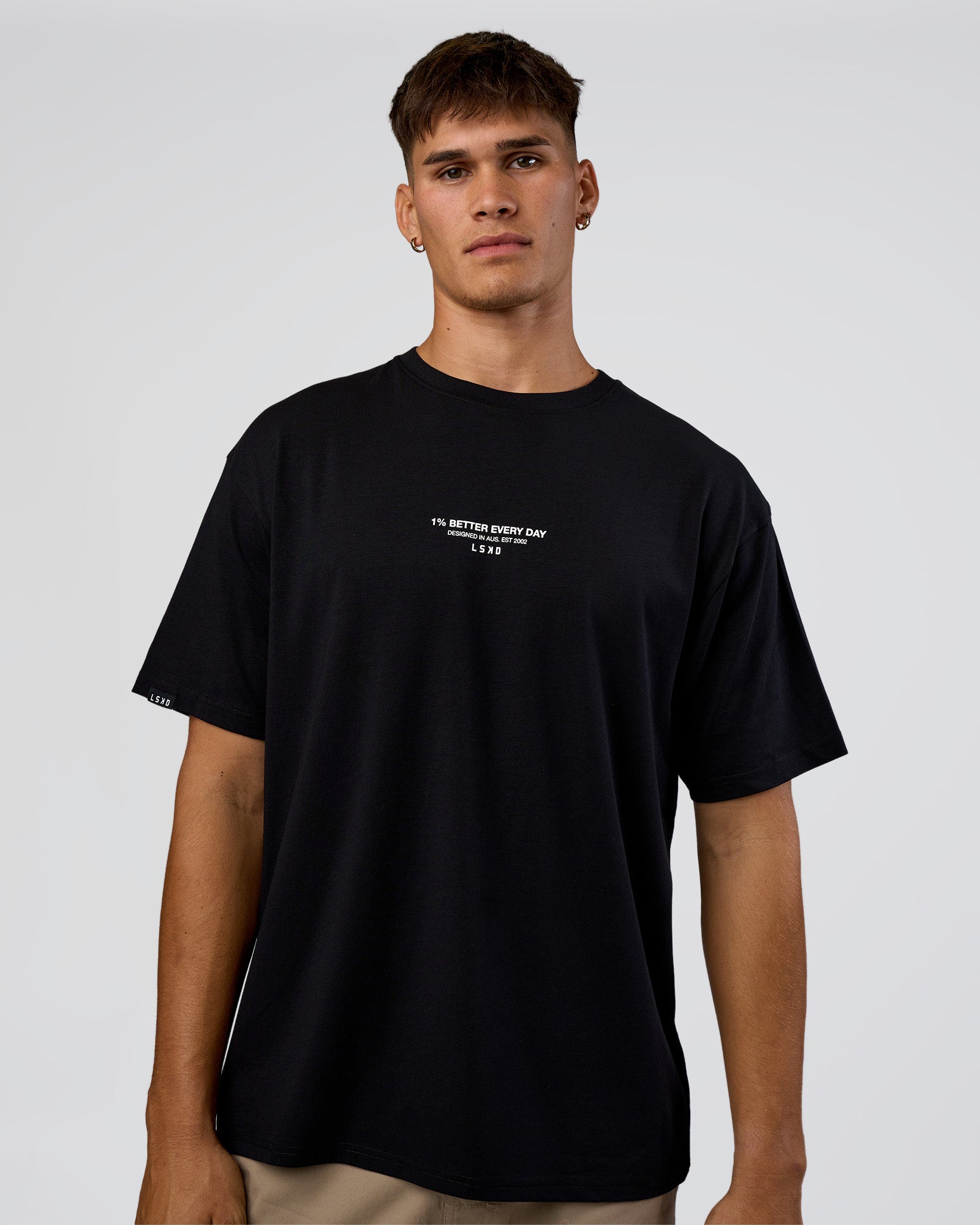 Man wearing 1% Better Every Day EST FLXCotton Oversized Tee - Black | Model:Jackson | Size:L