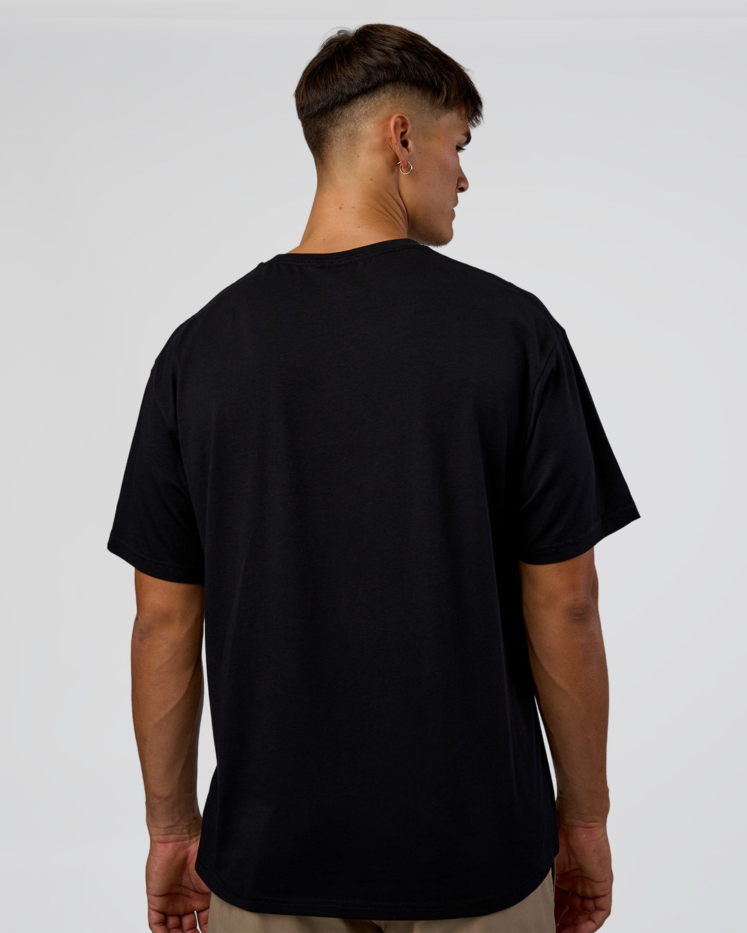 Man wearing 1% Better Every Day EST FLXCotton Oversized Tee - Black | Model:Jackson | Size:L
