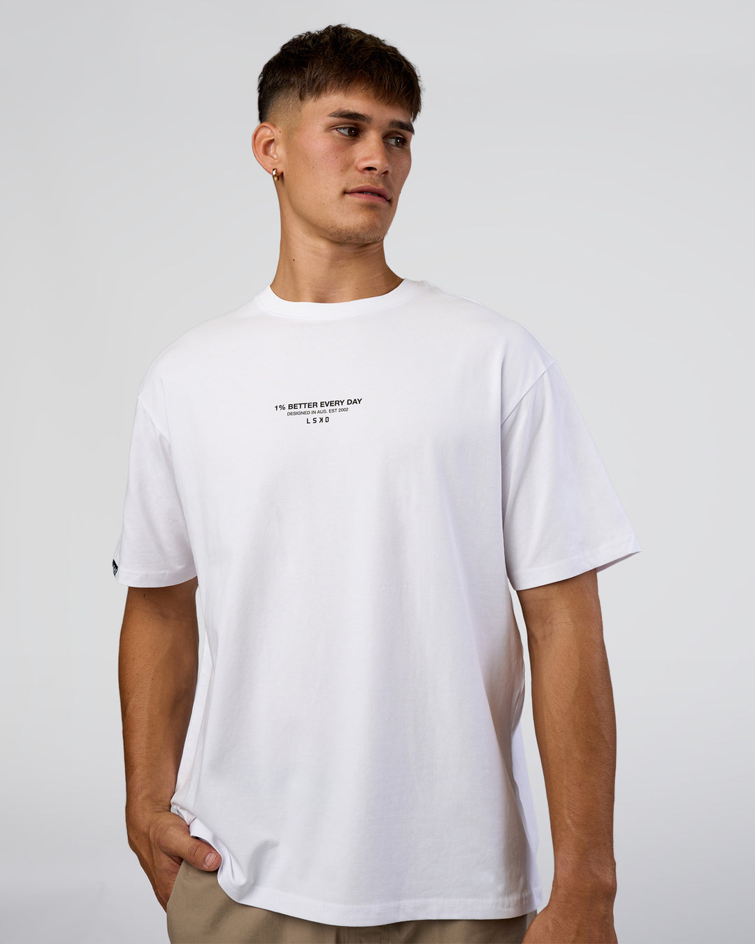 Man wearing 1% Better Every Day EST FLXCotton Oversized Tee - White | Model:Jackson | Size:L