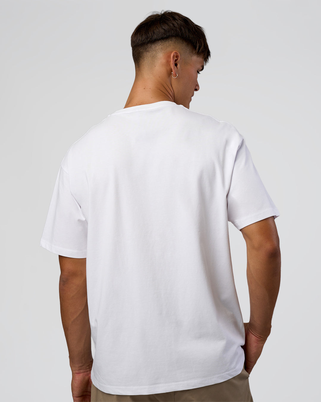 Man wearing 1% Better Every Day EST FLXCotton Oversized Tee - White | Model:Jackson | Size:L