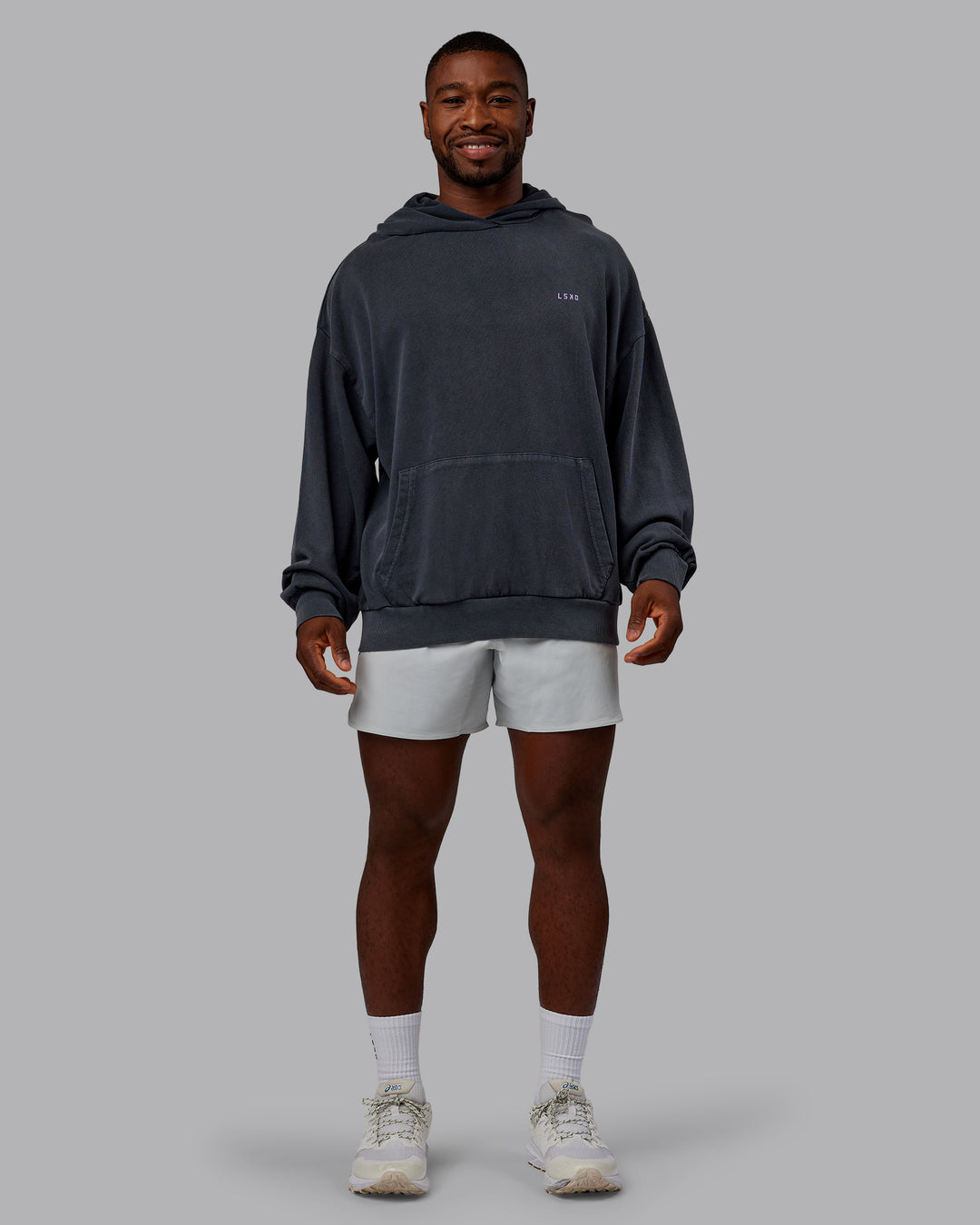 Man wearing 1% Better Value Series Oversized Hoodie - Black-Violet Ray | Model:Sam | Size:L