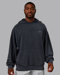 Man wearing 1% Better Value Series Oversized Hoodie - Black-Violet Ray | Model:Sam | Size:L