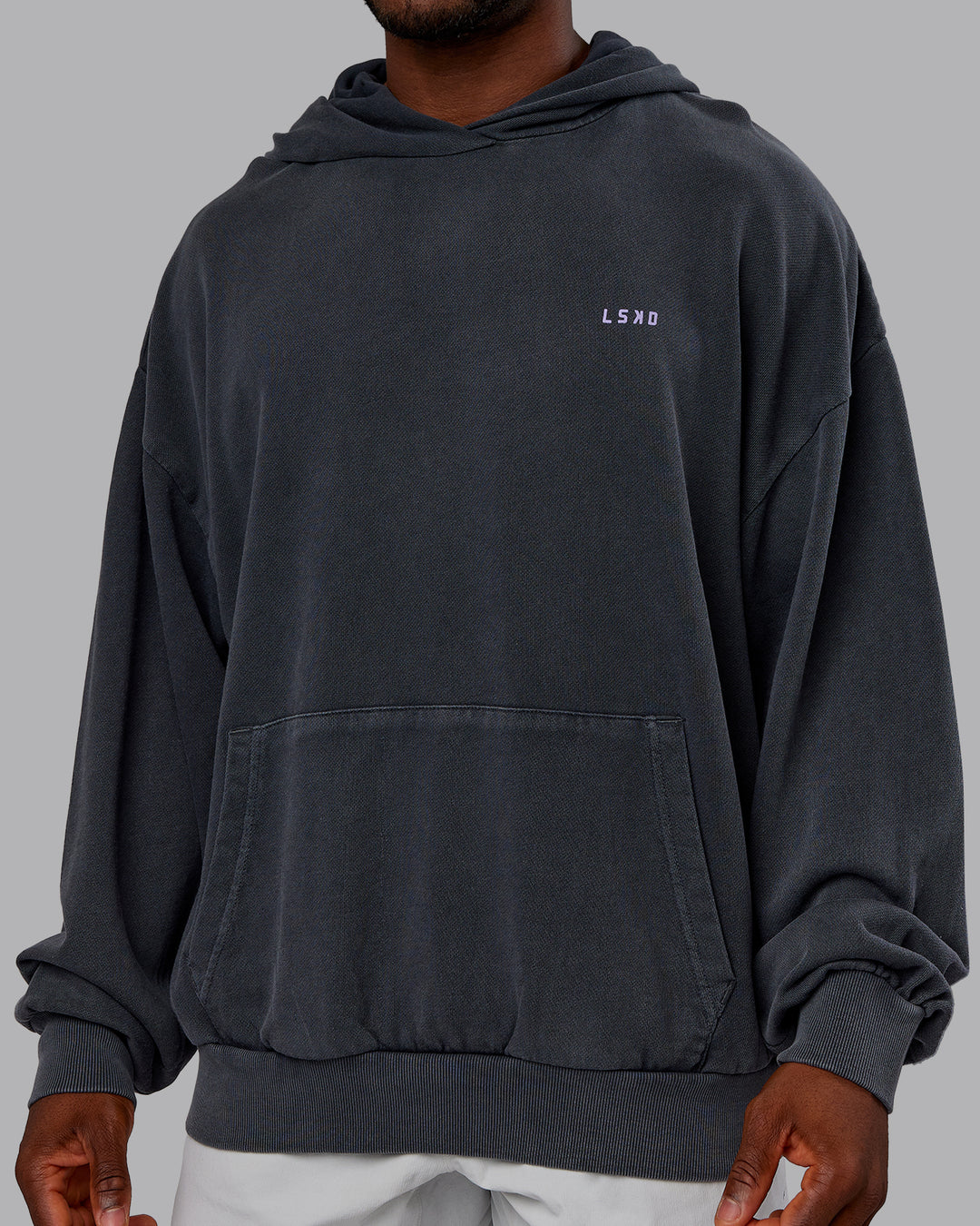Man wearing 1% Better Value Series Oversized Hoodie - Black-Violet Ray | Model:Sam | Size:L