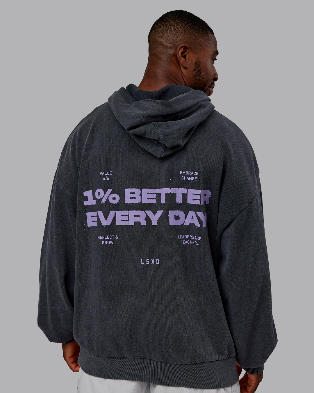 Man wearing 1% Better Value Series Oversized Hoodie - Black-Violet Ray | Model:Sam | Size:L