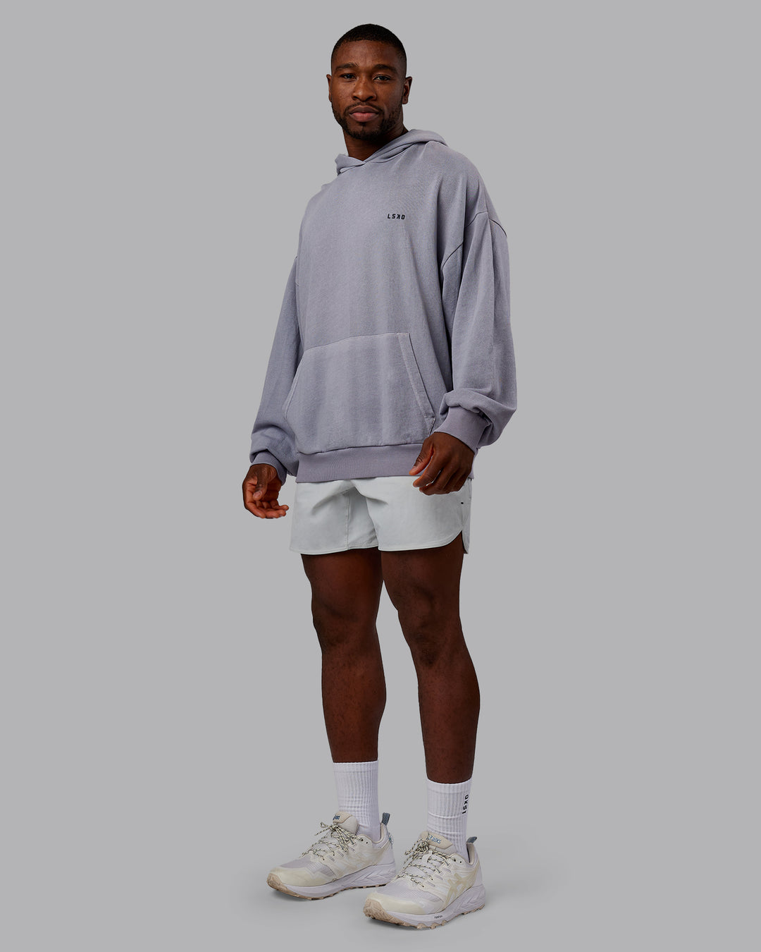Man wearing 1% Better Value Series Oversized Hoodie - Violet Ray-Black | Model:Sam | Size:L