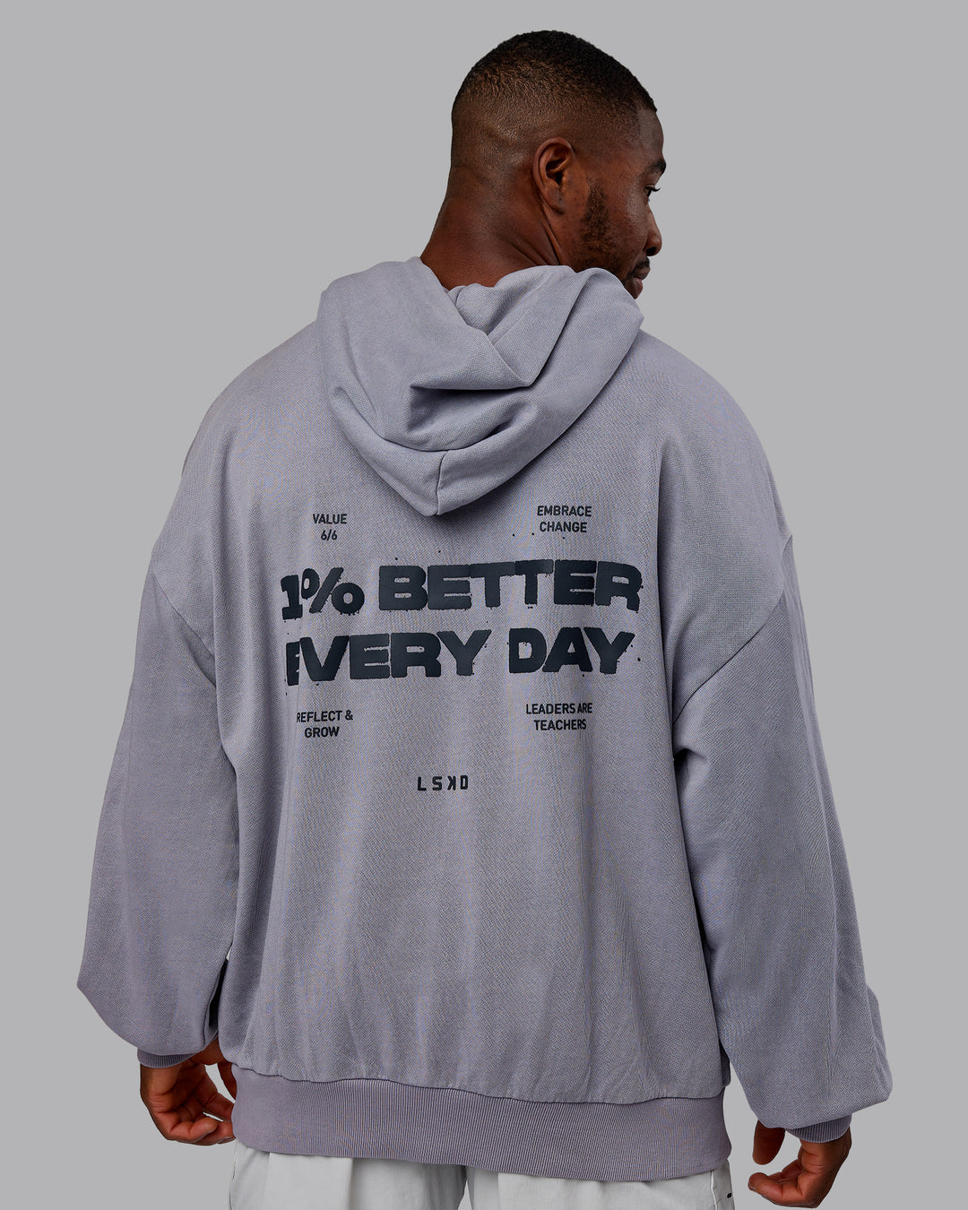 Man wearing 1% Better Value Series Oversized Hoodie - Violet Ray-Black | Model:Sam | Size:L