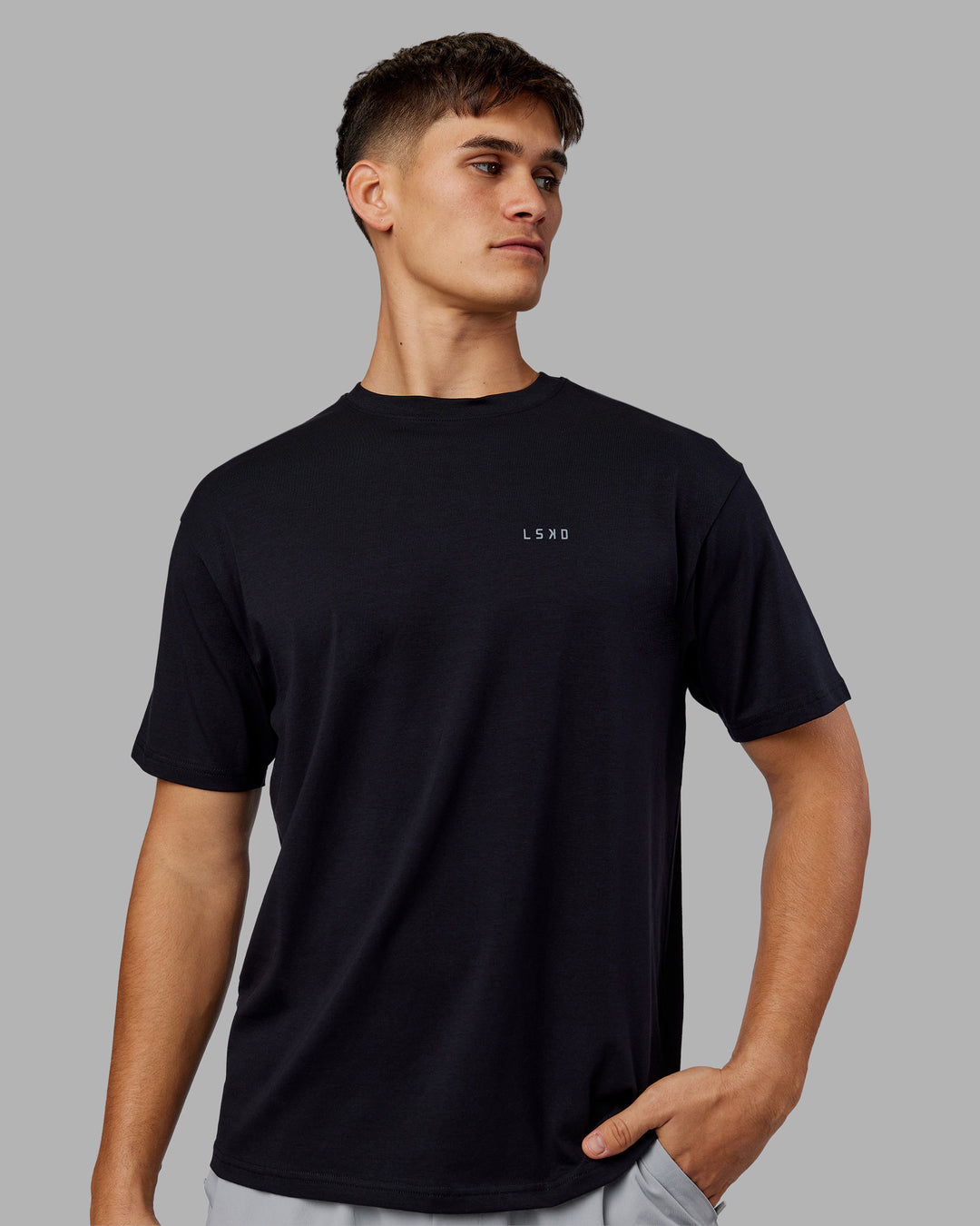 Man wearing 1% Better Value Series FLXCotton Tee Oversize - Black-Black | Model:Jackson | Size:L