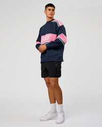 Man wearing A-Team Sweater Oversize - Future Navy-Candy Pink | Model:Jackson | Size:L